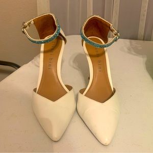 White closed toe heels with blue rhinestone ankle strap. Size 8.5.